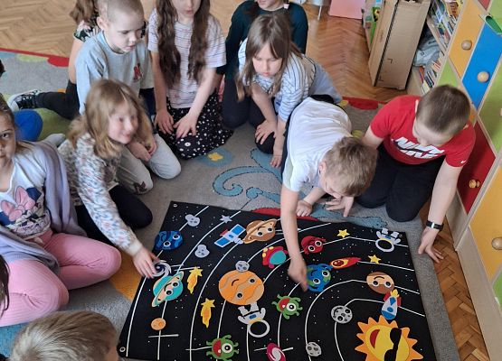 uczniowie oglądają makietę układu słonecznego