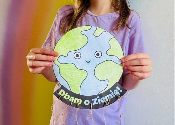 dziewczynka prezentuje swoją pracę plastyczną