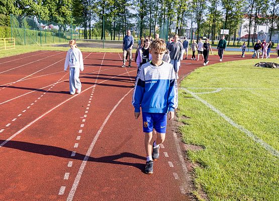 uczestnicy porannego marszu na szkolnym boisku